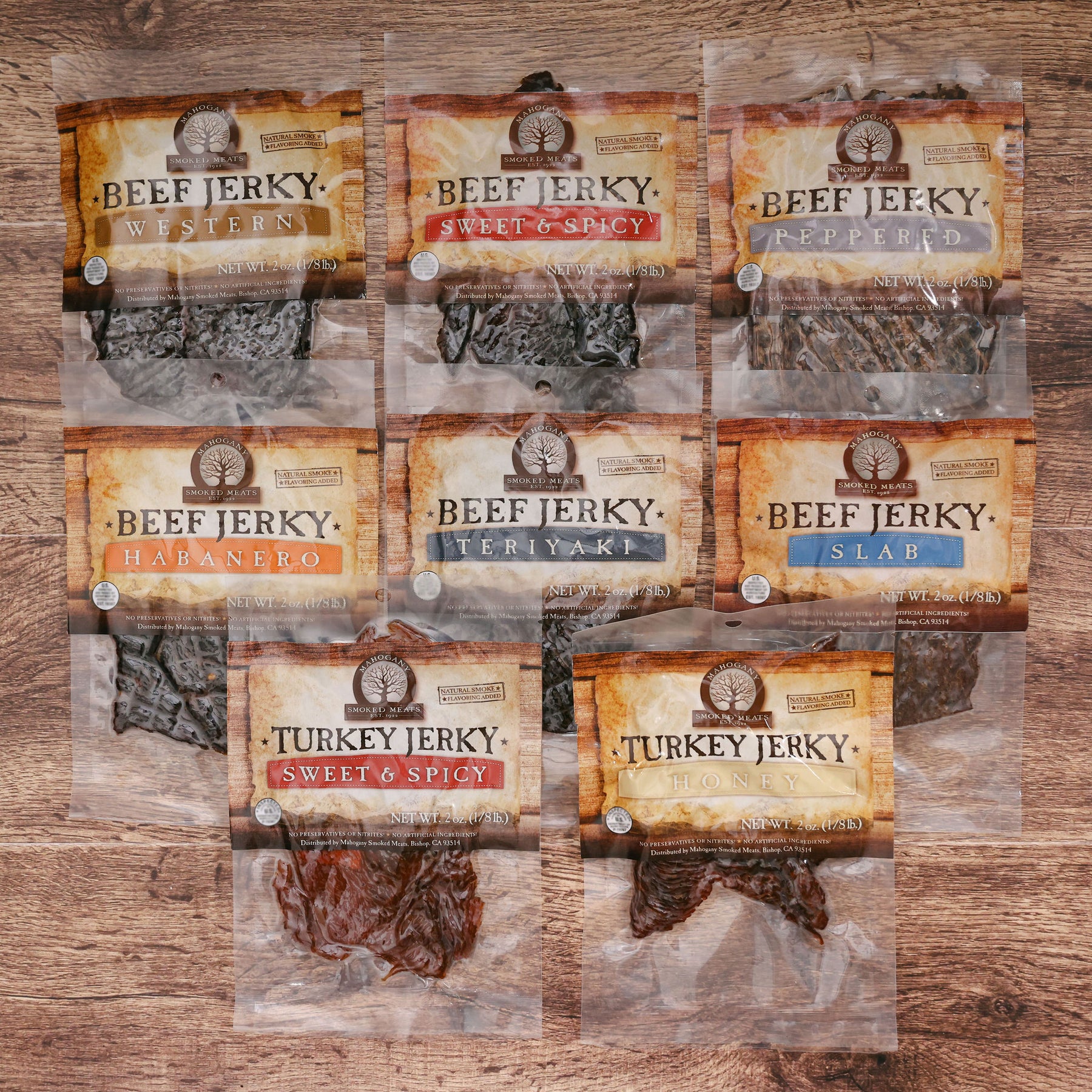 Assortment of nine beef and turkey jerky packages in various flavors on wooden background