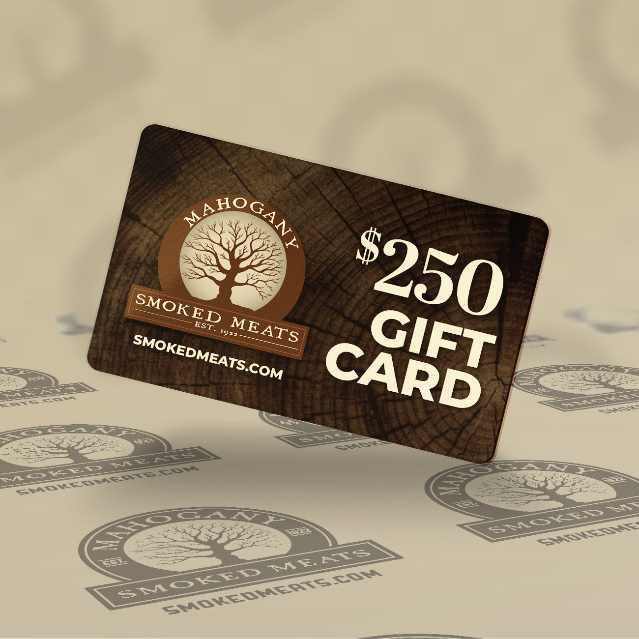 $250 Mahogany Smoked Meats gift card with a tree design on a wooden texture background