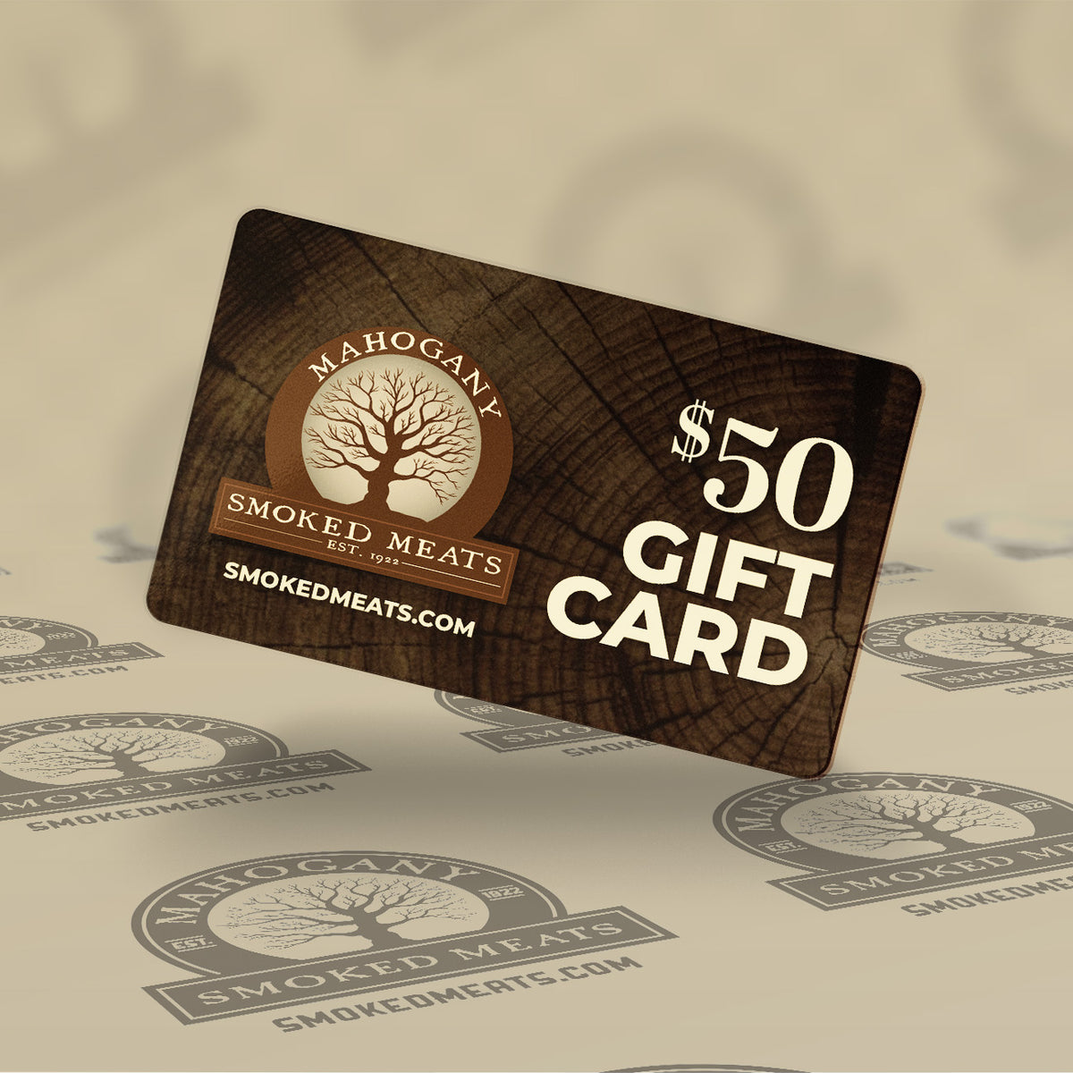 $50 Mahogany Smoked Meats gift card with tree logo on a wood grain background